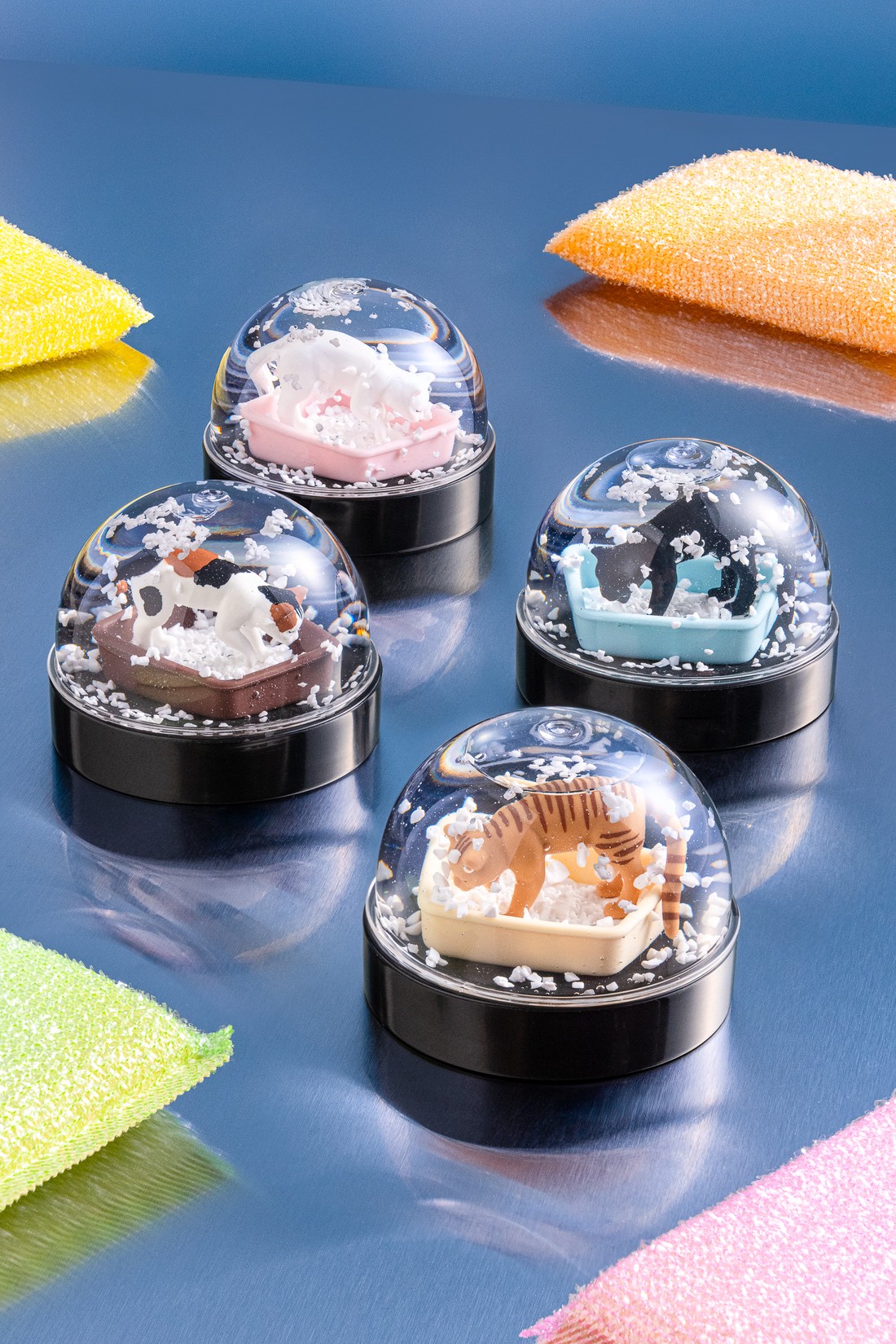 Kitan Club snow globe collectibles on a table
